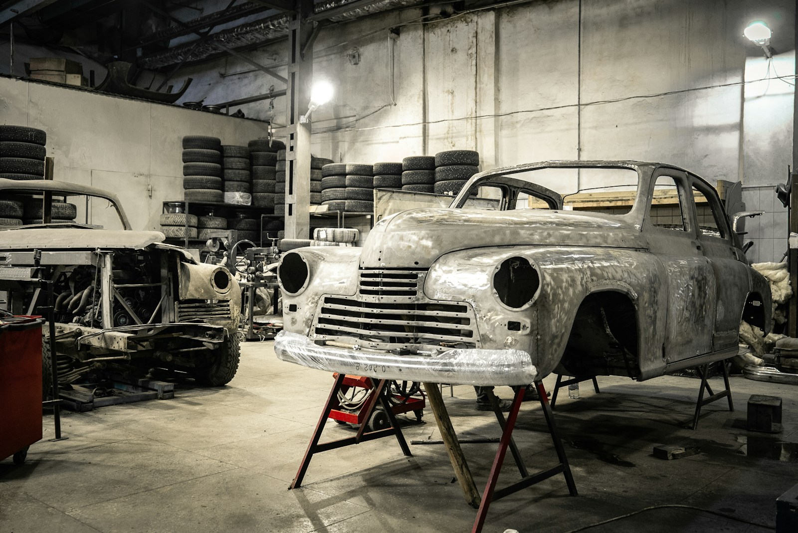 Classic car on a lift with rust repair in progress